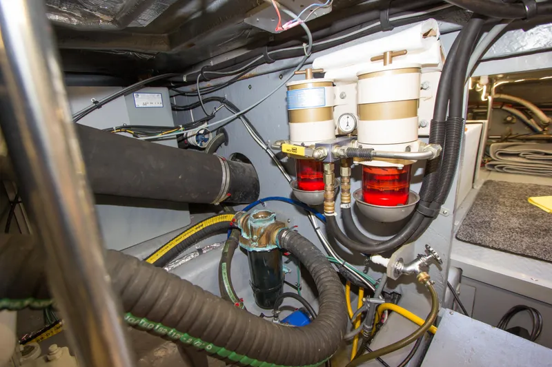 Slide: The Image of Engine room of 1998 Sea Ray 480 Sedan Bridge with fuel filters and hoses. - 42