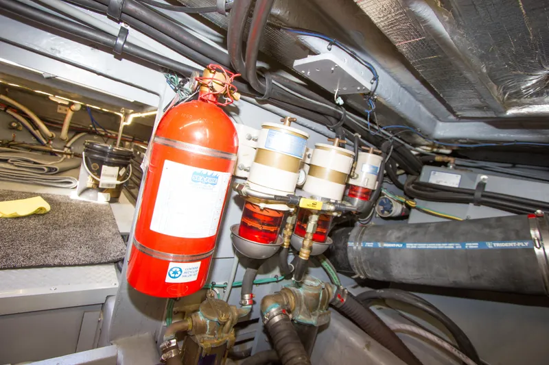Slide: The Image of Engine room of 1998 Sea Ray 480 Sedan Bridge with fire extinguisher and fuel filters. - 44