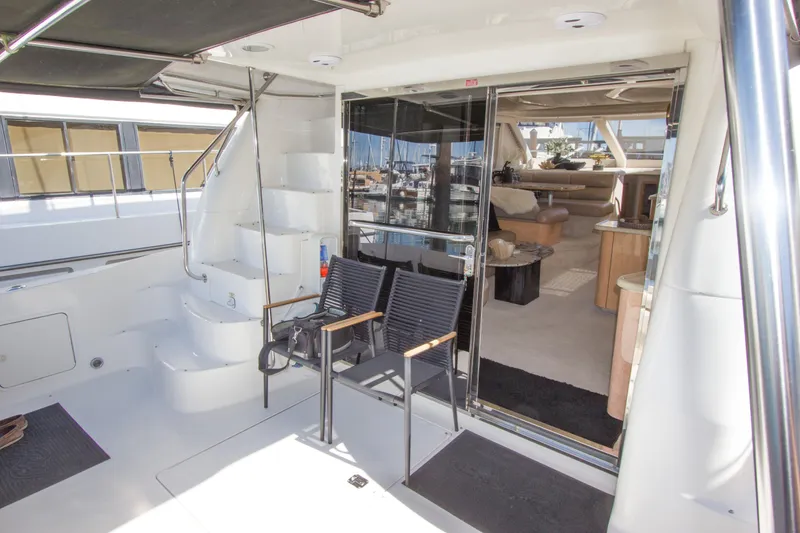 Slide: The Image of 1998 Sea Ray 480 Sedan Bridge yacht interior with seating and staircase. - 9