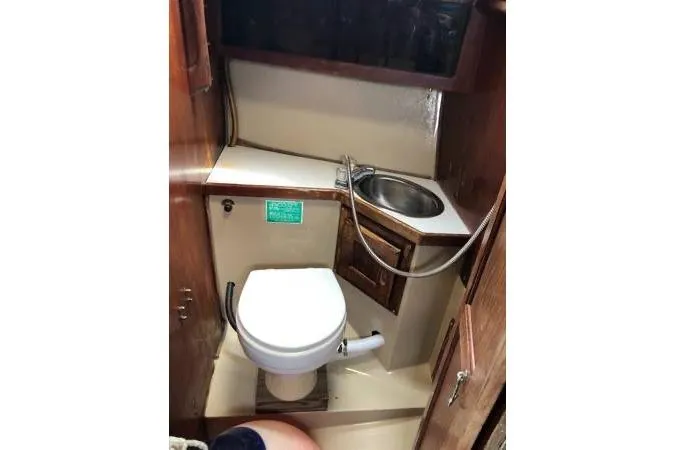 Slide: The Image of 1981 Catalina 30 boat bathroom with toilet and sink. - 13