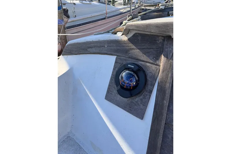 Slide: The Image of Compass on 1981 Catalina 30 sailboat with wooden paneling and nautical equipment. - 14