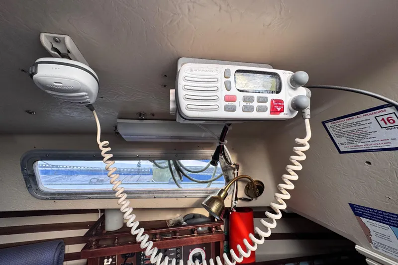 Slide: The Image of Interior of 1981 Catalina 30 sailboat with radio equipment and emergency instructions. - 15