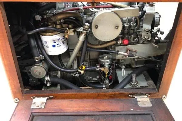 Slide: The Image of Engine compartment of a 1981 Catalina 30 sailboat, showcasing mechanical components and wiring. - 18