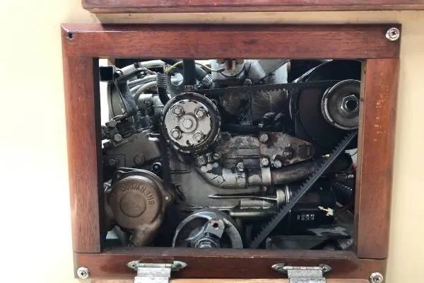 Slide: The Image of Engine compartment of a 1981 Catalina 30 sailboat, showcasing mechanical components. - 19