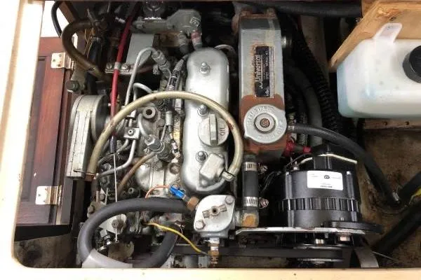 Slide: The Image of Engine compartment of a 1981 Catalina 30 sailboat, showcasing mechanical components and wiring. - 20