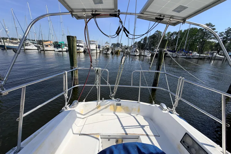 Slide: The Image of 1981 Catalina 30 yacht kitchen with stove, sink, and wooden cabinetry. - 25