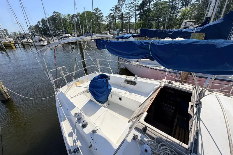 Slide: The Image of Interior view of a 1981 Catalina 30 sailboat with wooden cabinetry and storage compartment. - 27