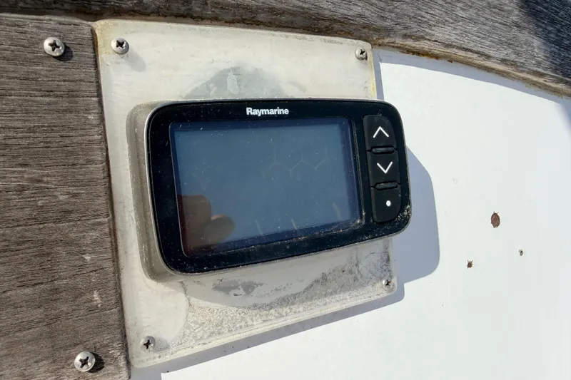 Slide: The Image of Interior of a 1981 Catalina 30 sailboat with wood paneling and blue seating. - 29