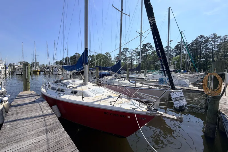 Slide: The Image of Interior of 1981 Catalina 30 sailboat with wooden furnishings and blue upholstery. - 31