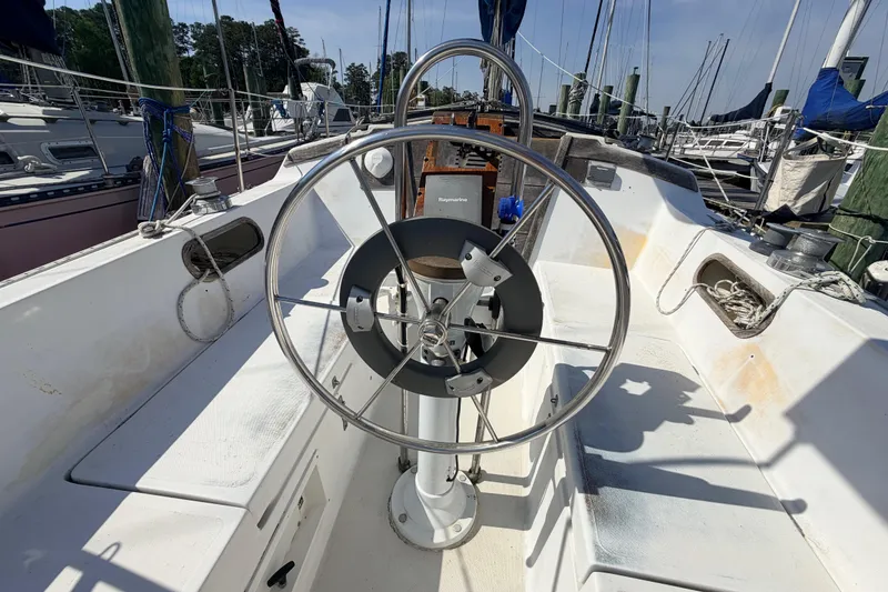 Slide: The Image of Interior of a 1981 Catalina 30 sailboat with wooden cabinetry and compact kitchen area. - 33
