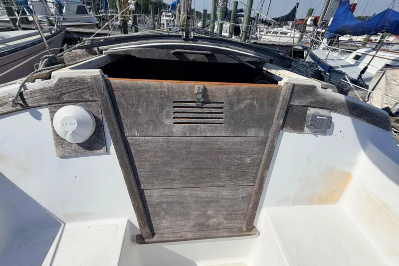 Slide: The Image of Interior of a 1981 Catalina 30 sailboat featuring a compact kitchen and seating area. - 37