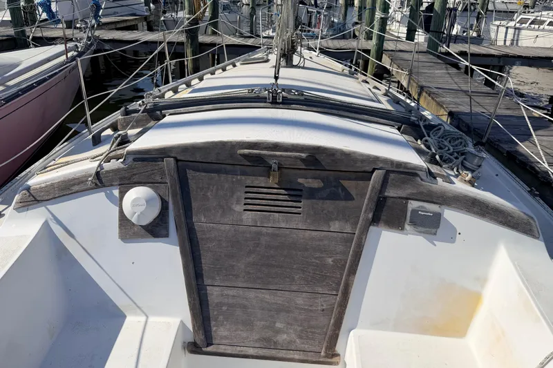 Slide: The Image of Interior of a 1981 Catalina 30 sailboat featuring a compact kitchen with wooden cabinetry. - 38