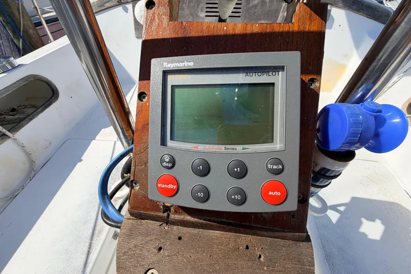 Slide: The Image of Interior of a 1981 Catalina 30 sailboat with wooden cabinetry and blue seating. - 39