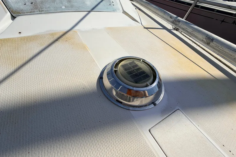 Slide: The Image of Interior of a 1981 Catalina 30 sailboat with wooden cabinetry and blue seating. - 41