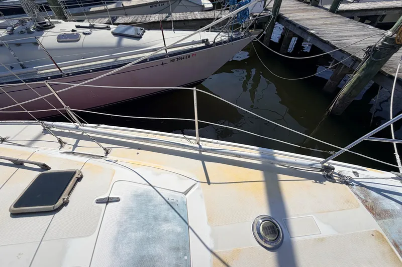 Slide: The Image of Interior of a 1981 Catalina 30 sailboat with blue seating and wooden accents. - 43