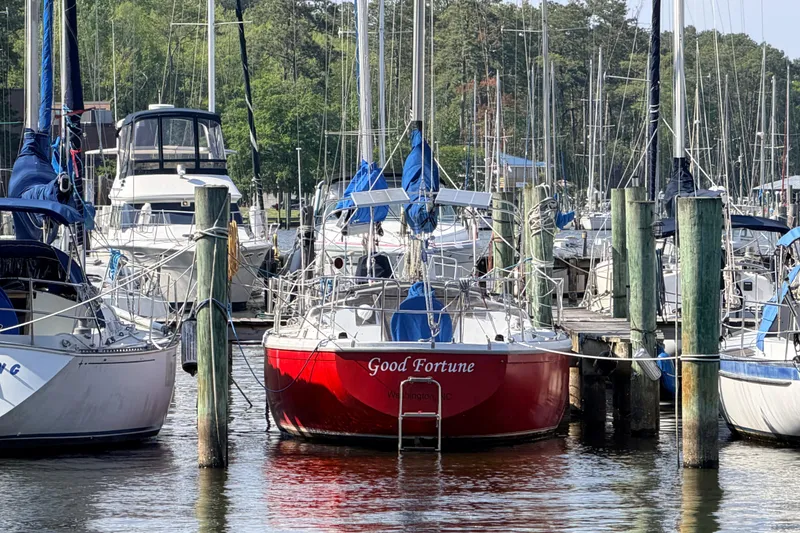 Slide: The Image of Interior of a 1981 Catalina 30 sailboat with blue cushioned seating and wooden cabinetry. - 44