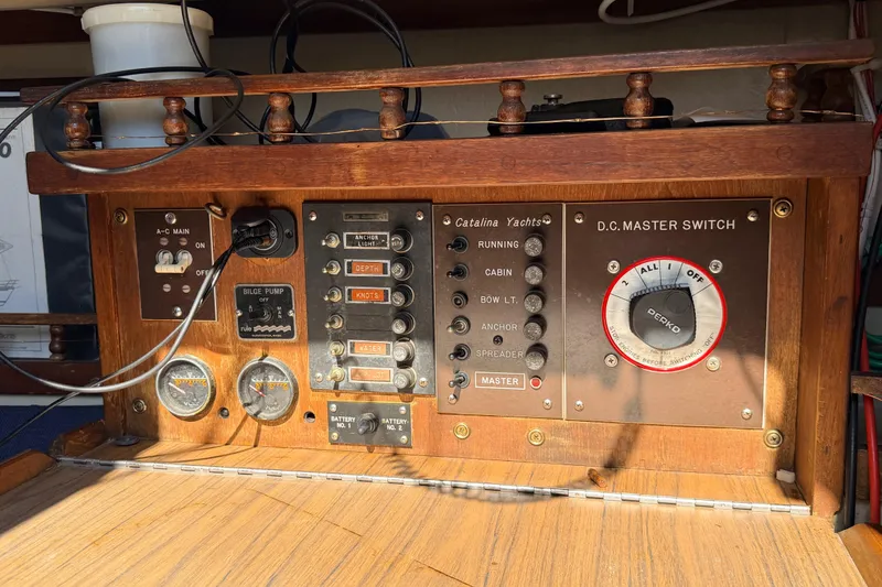 Slide: The Image of Interior of a 1981 Catalina 30 sailboat with blue cushioned seating. - 45