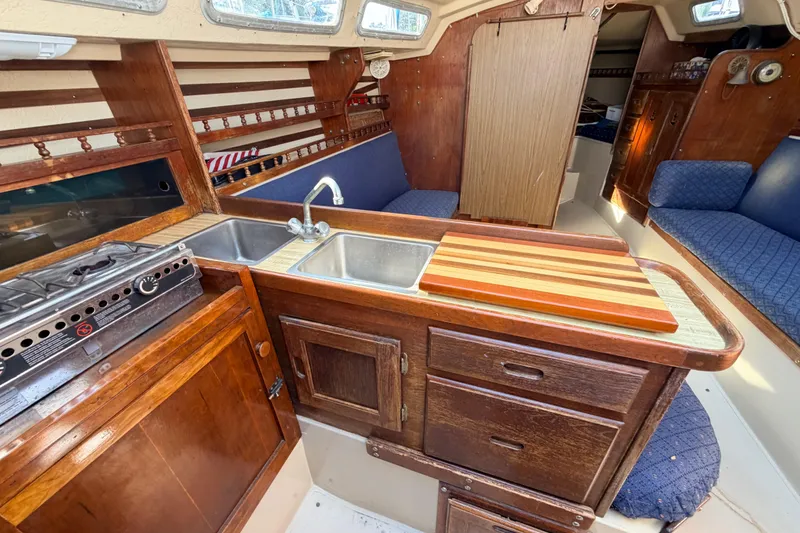 Slide: The Image of Interior of 1981 Catalina 30 sailboat showing shower head and wooden cabinetry. - 50