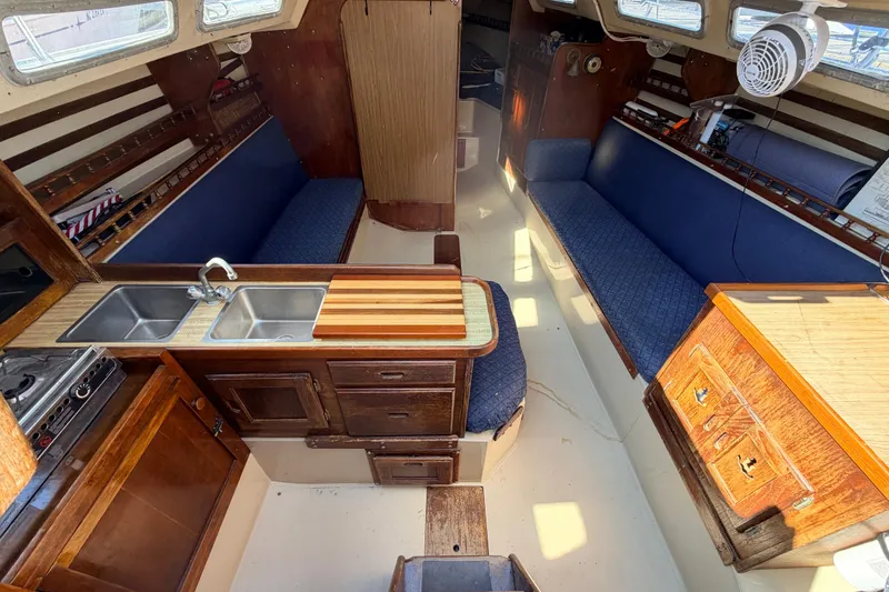 Slide: The Image of Stainless steel sink in 1981 Catalina 30 boat with vintage faucet and wooden countertop. - 51