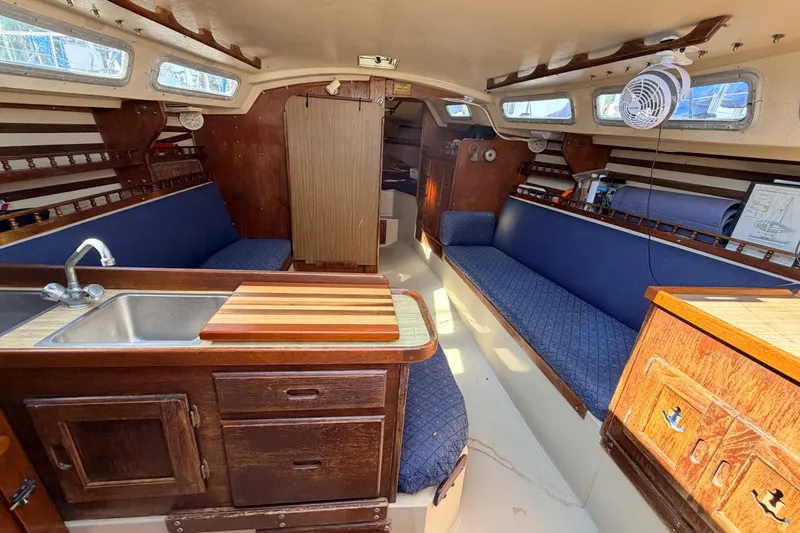 Slide: The Image of Interior of 1981 Catalina 30 sailboat with wooden cabinetry and cozy sleeping area. - 54
