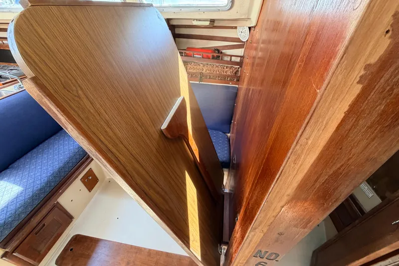 Slide: The Image of Engine compartment of a 1981 Catalina 30 sailboat, showcasing mechanical components. - 58