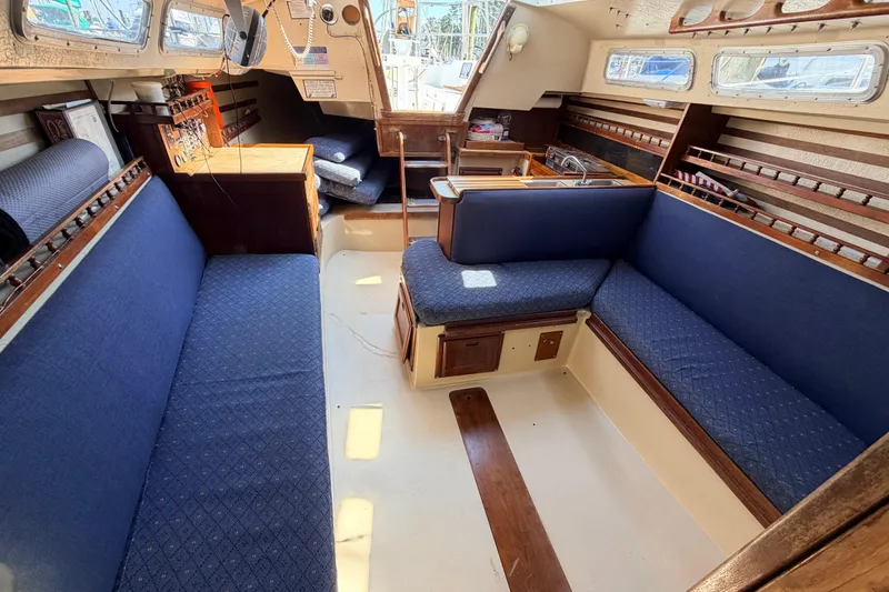 Slide: The Image of Engine compartment of a 1981 Catalina 30 sailboat, showcasing mechanical components and wiring. - 59