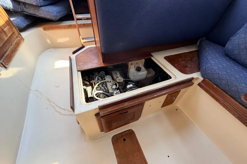 Slide: The Image of 1981 Catalina 30 sailboat interior showing engine compartment and seating area. - 60