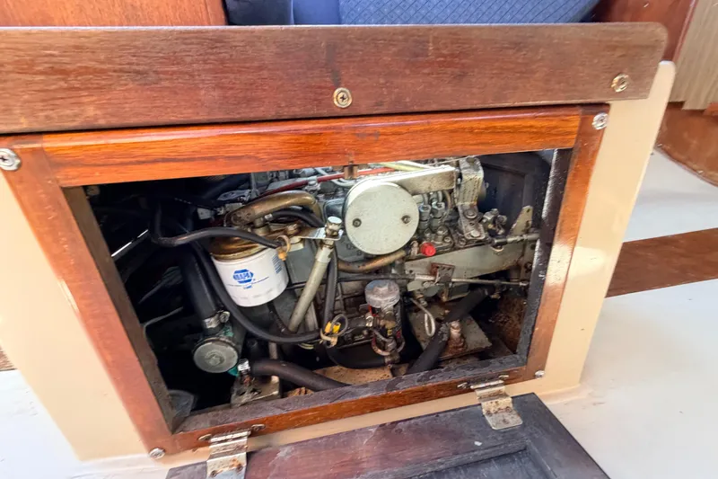 Slide: The Image of Engine compartment of a 1981 Catalina 30 sailboat, showing mechanical components and hoses. - 61