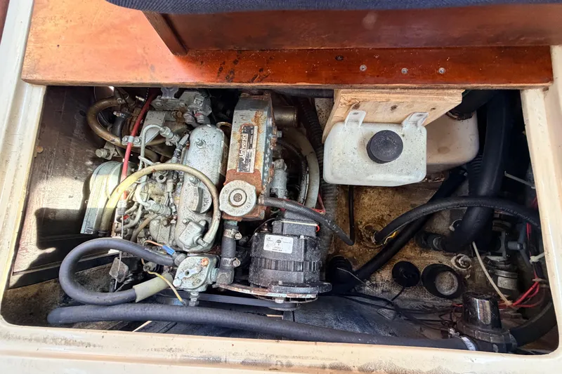 Slide: The Image of 1981 Catalina 30 sailboat with red hull sailing on open water. - 62