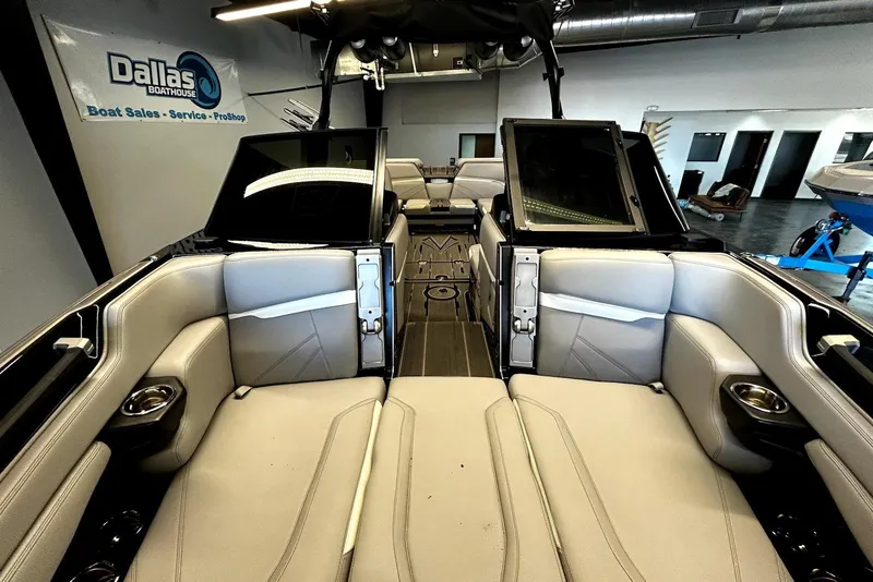 Slide: The Image of 2023 Supra SA 450 boat interior with luxurious seating at Dallas Boathouse showroom. - 5