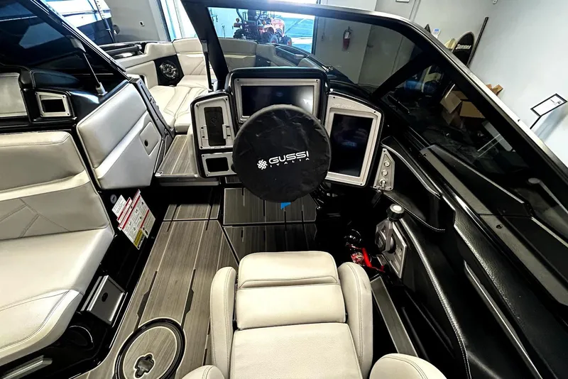 Slide: The Image of Interior of 2023 Supra SA 450 boat with modern dashboard and seating. - 6