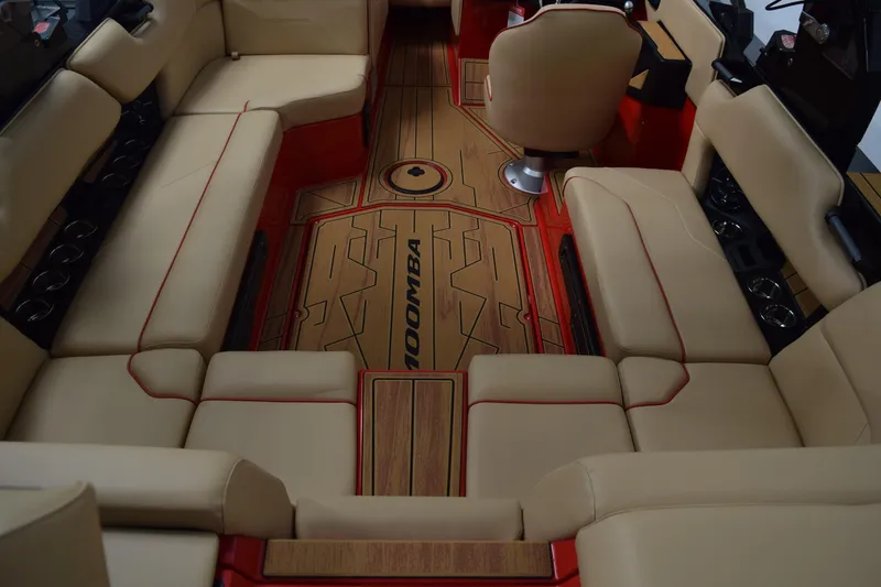 Slide: The Image of 2026 Moomba Max boat interior with beige seating and red accents. - 10