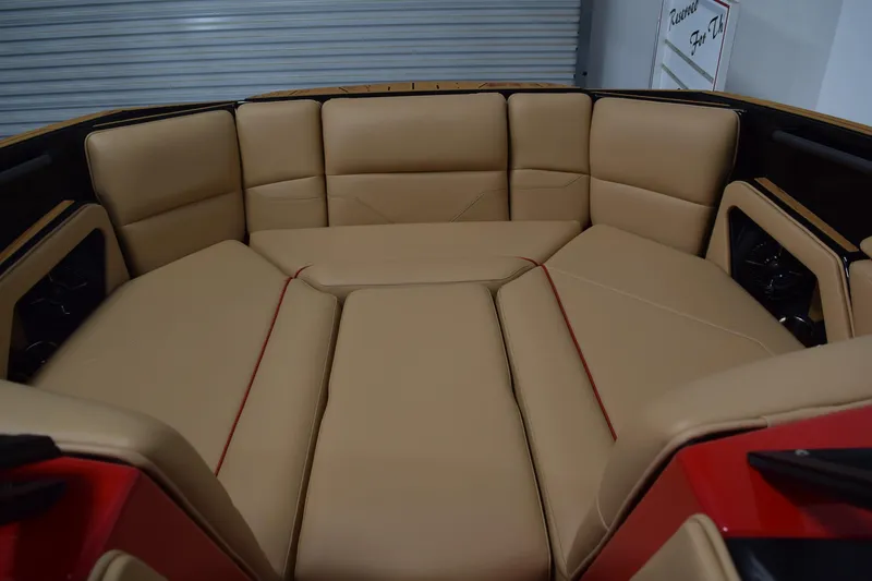 Slide: The Image of 2026 Moomba Max boat interior with tan leather seating and red accents. - 18