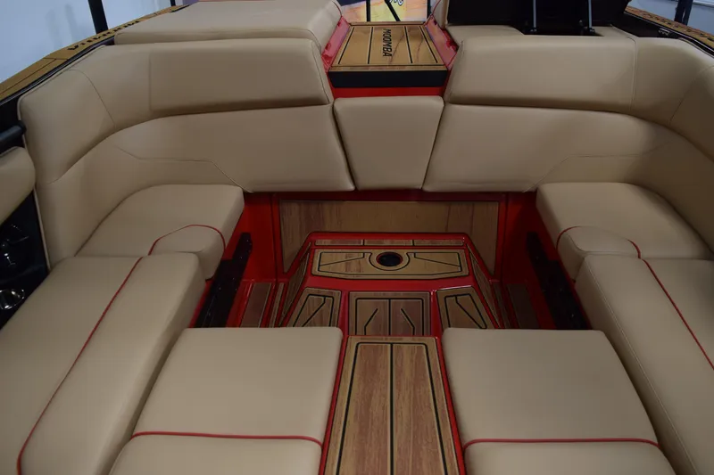 Slide: The Image of 2026 Moomba Max boat interior with beige seating and red accents. - 21