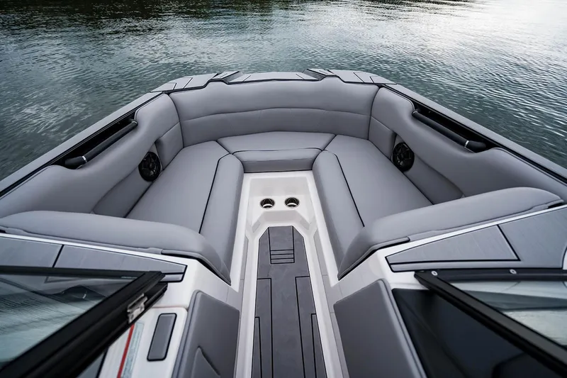 Slide: The Image of Manufacturer Provided Image: 2026 Moomba Max boat interior with gray seating, cup holders, and water view. - 22