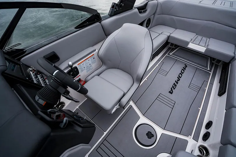 Slide: The Image of Manufacturer Provided Image: 2026 Moomba Max boat interior with sleek gray seating and modern dashboard design. - 23