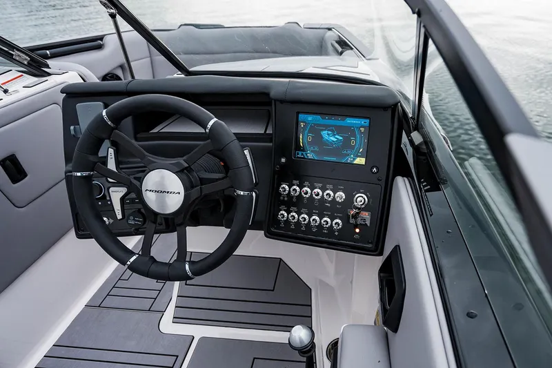 Slide: The Image of Manufacturer Provided Image: 2026 Moomba Max boat dashboard with steering wheel and digital display on water. - 25