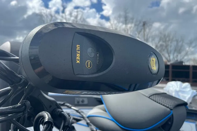 Slide: The Image of 2026 Xpress XR21 Bass boat with Minn Kota Ultrex motor, under a cloudy sky. - 14