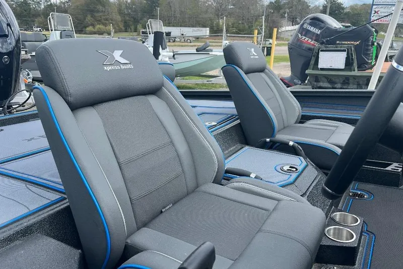 Slide: The Image of 2026 Xpress XR21 Bass boat interior with gray and blue seating, showcasing modern design. - 15