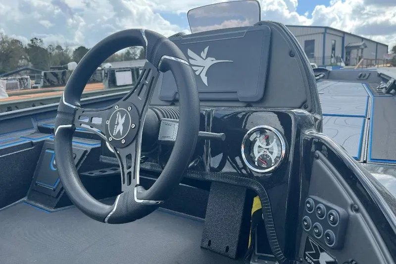 Slide: The Image of Interior view of 2026 Xpress XR21 Bass boat with steering wheel and dashboard controls. - 19