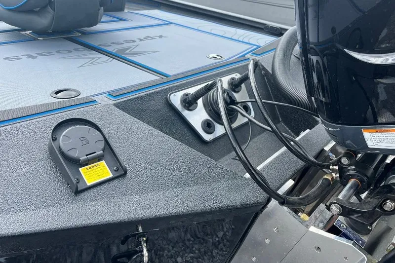 Slide: The Image of 2026 Xpress XR21 Bass boat deck with motor cables and storage compartment. - 20