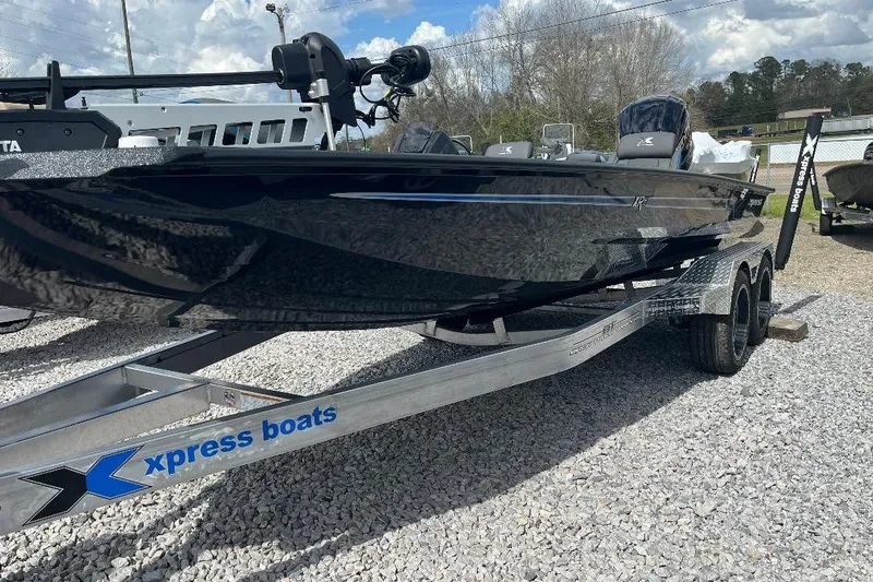 Slide: The Image of 2026 Xpress XR21 Bass boat on trailer, displayed outdoors on gravel. - 5