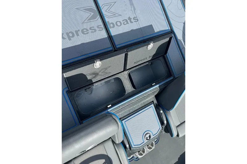 Slide: The Image of 2026 Xpress XR21 Bass boat interior storage compartments with sleek design and blue accents. - 9