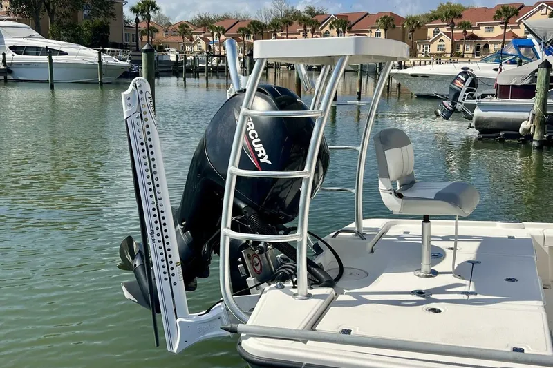 Slide: The Image of 2021 Mako 21 LTS boat with Mercury engine docked in marina. - 12