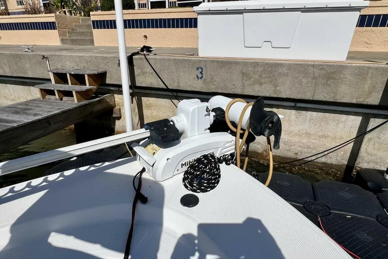 Slide: The Image of 2021 Mako 21 LTS boat with trolling motor docked at marina. - 19