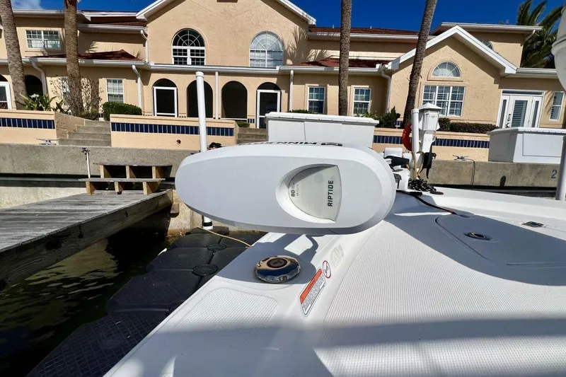 Slide: The Image of 2021 Mako 21 LTS boat docked near waterfront homes, featuring a Riptide motor. - 20