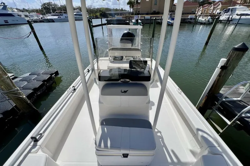 Slide: The Image of 2021 Mako 21 LTS boat docked at marina, featuring spacious deck and console. - 30