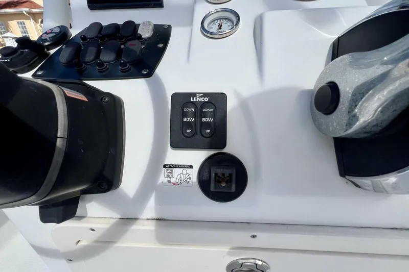 Slide: The Image of Control panel of a 2021 Mako 21 LTS boat with switches and gauges. - 34