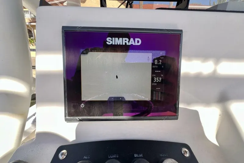 Slide: The Image of Simrad display on 2021 Mako 21 LTS boat dashboard, showing navigation data. - 38