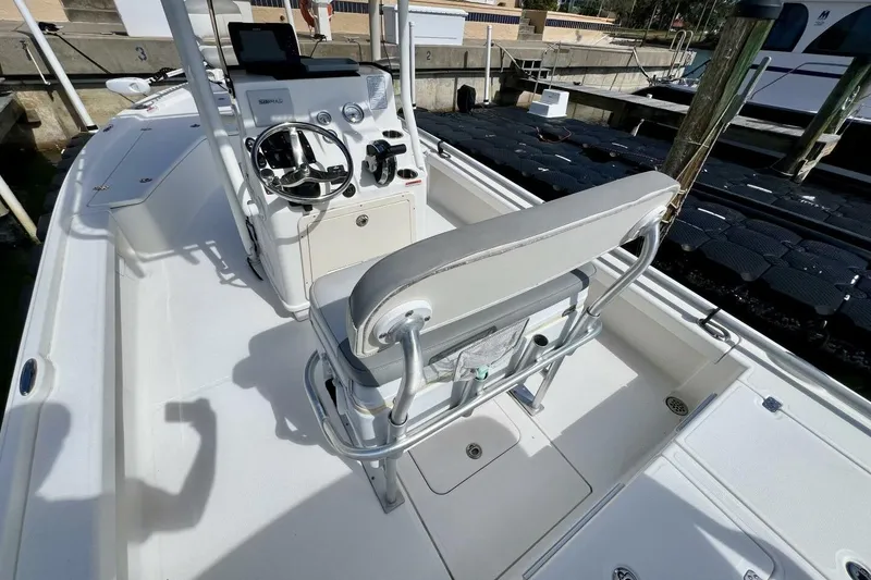 Slide: The Image of 2021 Mako 21 LTS boat interior with steering console and seating. - 4